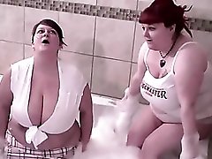 Two chunky redhead babes play in the bathtub
