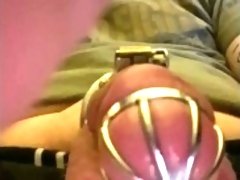 Caged sissy cumming with a vibrator